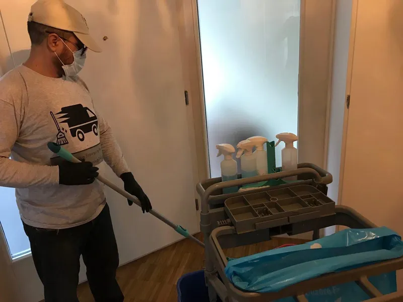 Mitarbeiter mit Reinigungswagen